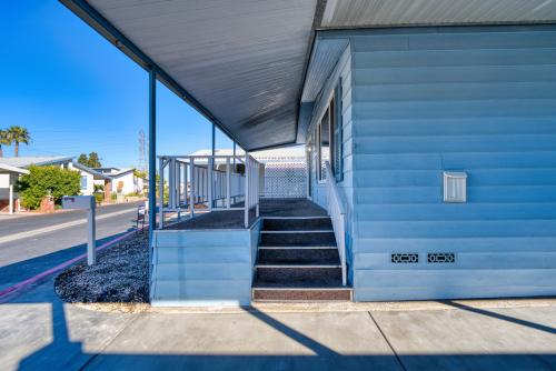 The front porch of a blue mobile home.