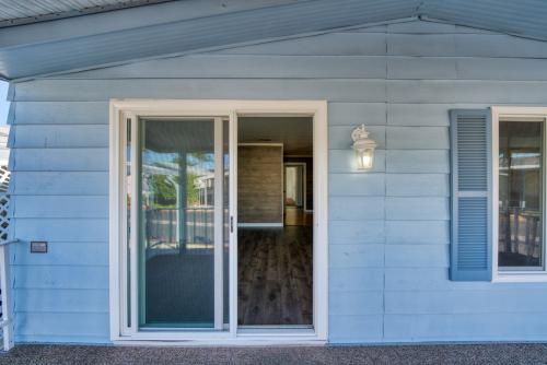 A blue mobile home with a sliding glass door.