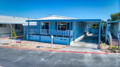 A blue mobile home in a parking lot.